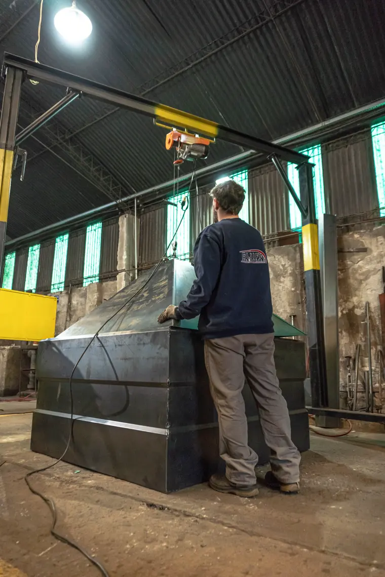 Worker next to a hopper body in the plant's shed