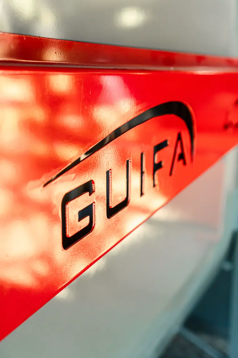 Guifa logo cut into red sheet metal