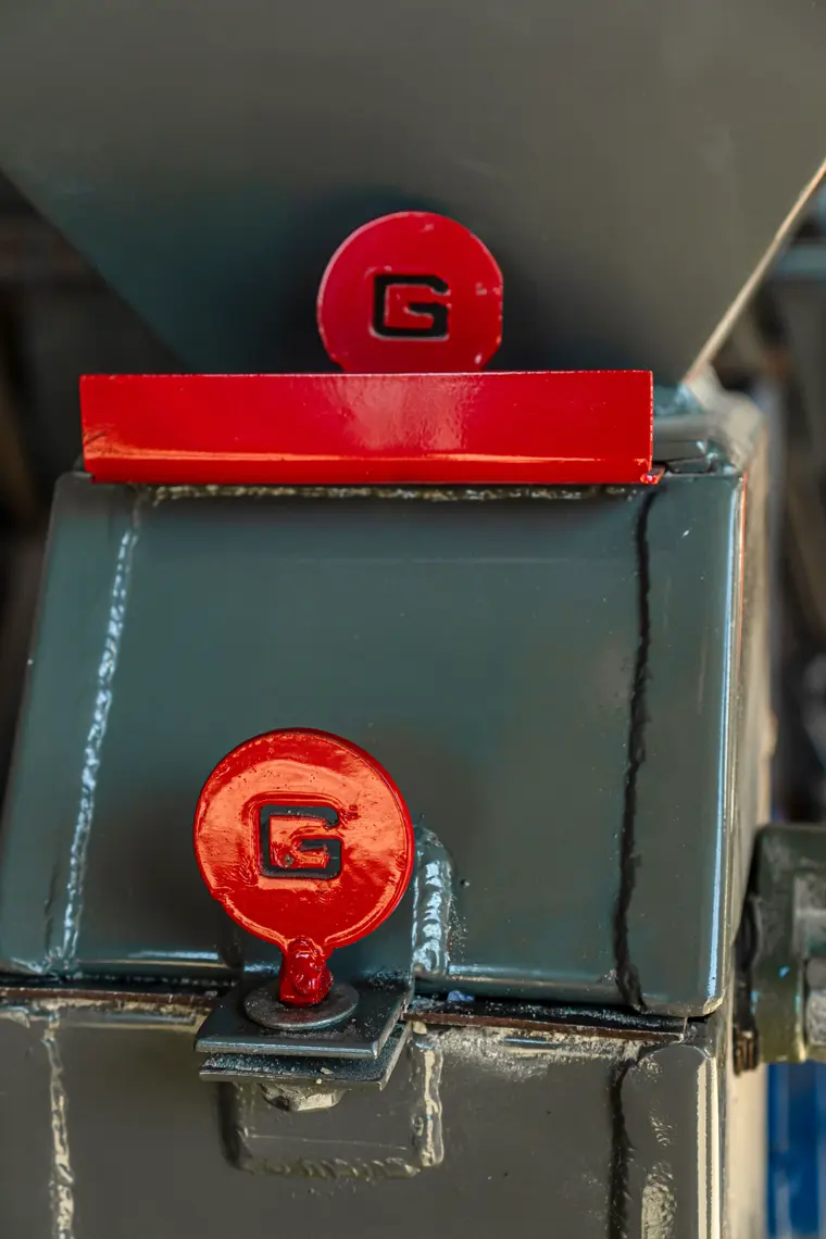 Red caps with the Guifa G on a gray hopper